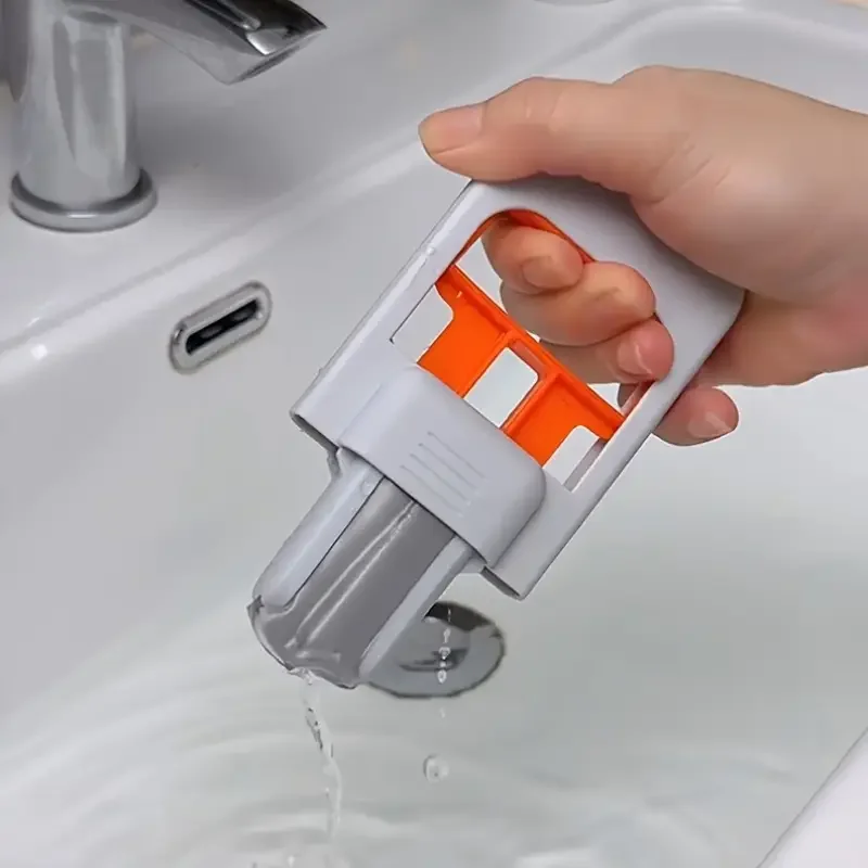Mini mop squeezing water out over a sink, showing flexible squeegee edge.