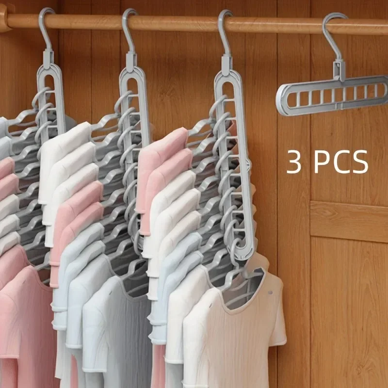 Set of three gray hangers with clothes on a wooden background, labeled '3 PCS'.