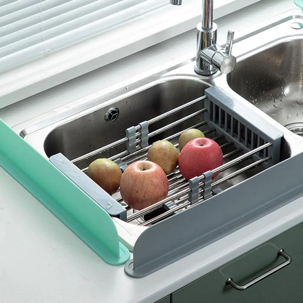 Sink with a fruit drying rack holding apples, next to a window and faucet.