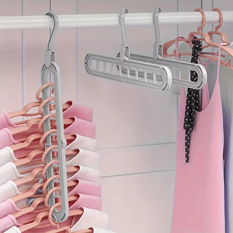 Multi-layered hanger with clothes on a pink background