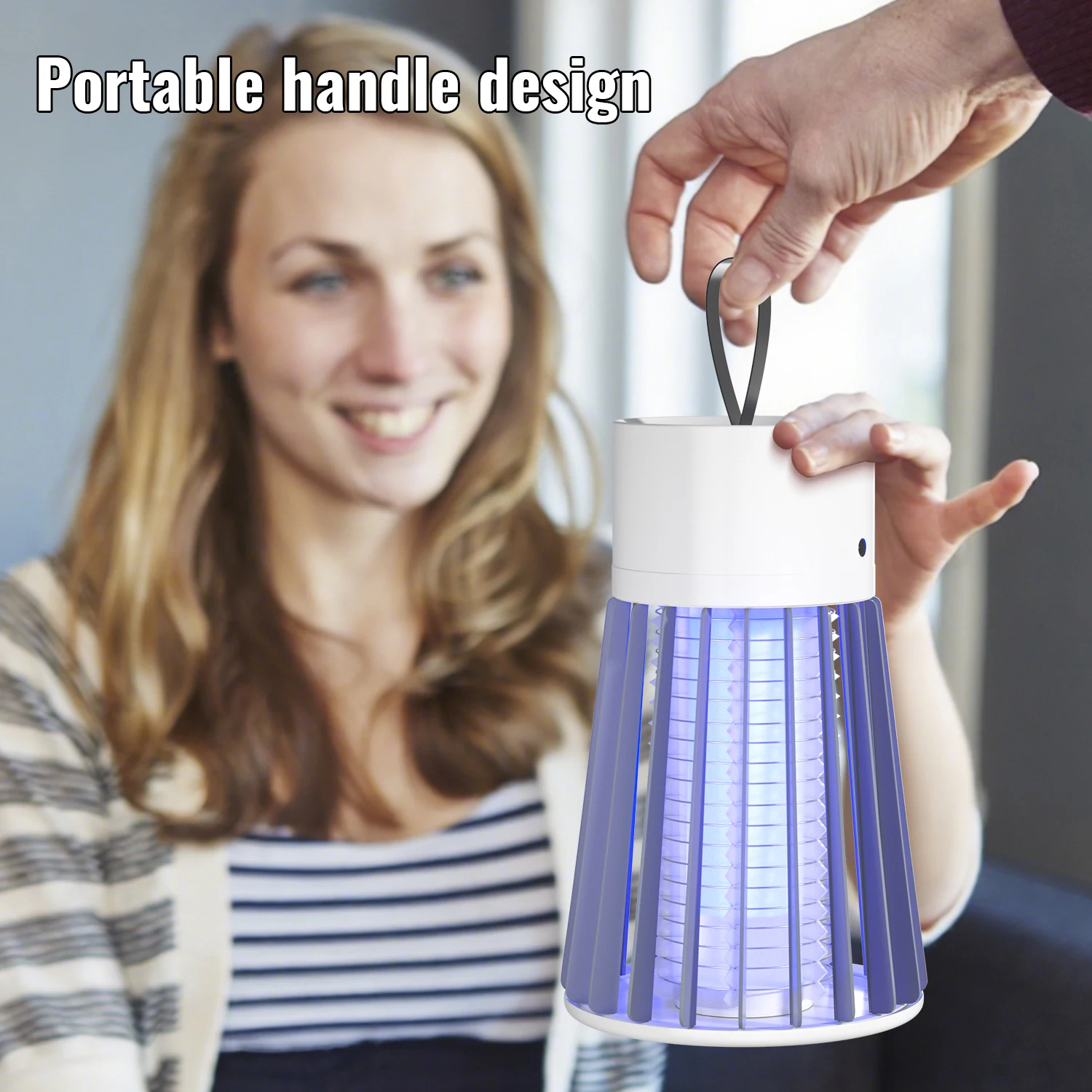 Woman holding a portable lamp with a visible handle, smiling.