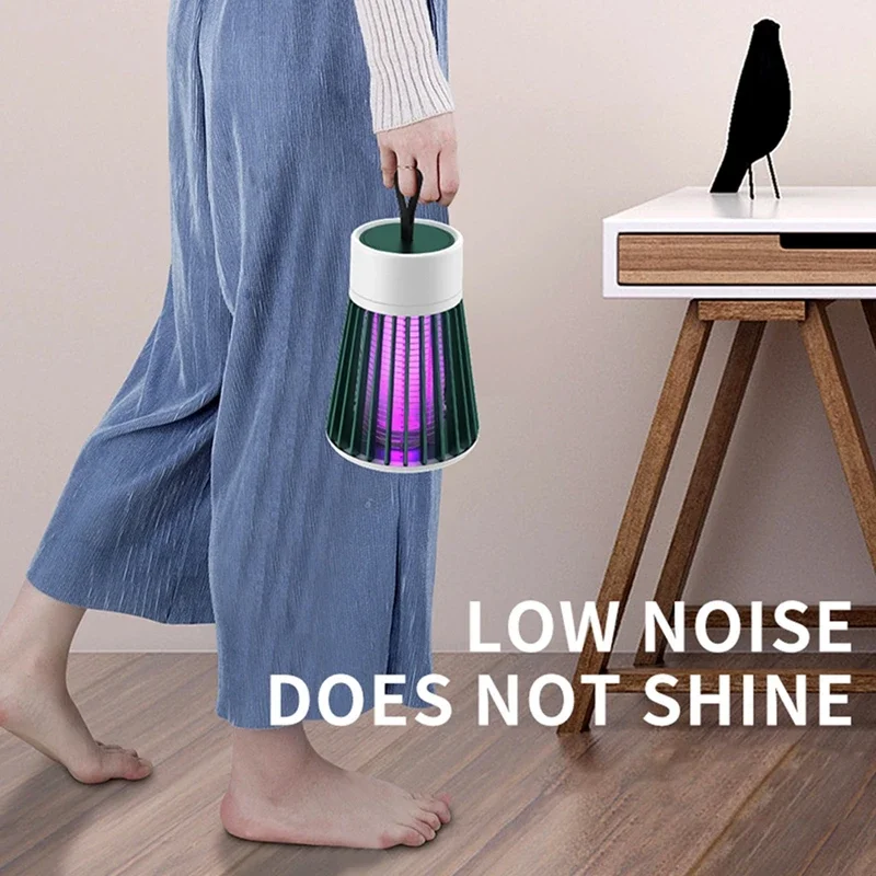 Person holding a small, colorful lamp with text 'LOW NOISE DOES NOT SHINE' in a room setting.
