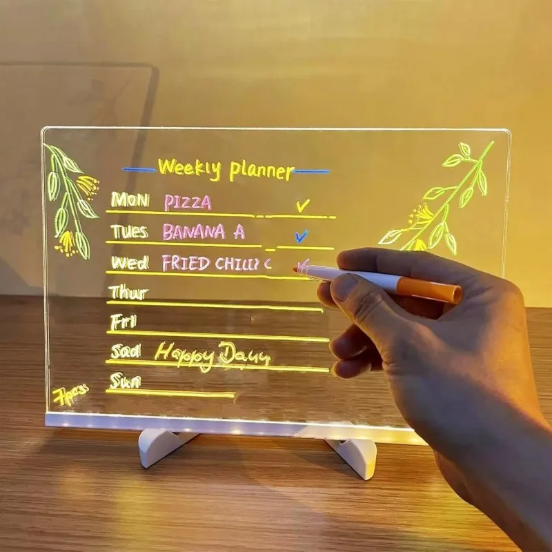 Weekly planner on a transparent board with a hand holding a marker.