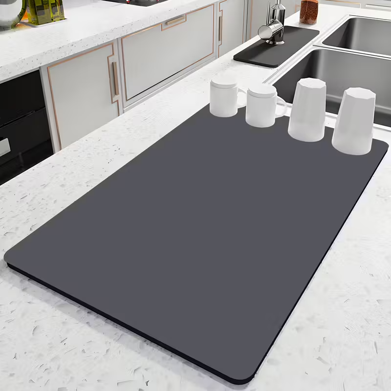 Gray mat on a kitchen counter with white cups