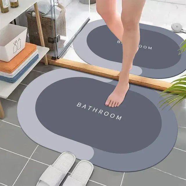 Person stepping onto a round bathroom mat with 'Bathroom' text on a tiled floor.