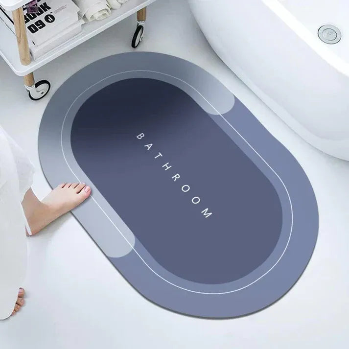 Gray bath mat with 'Bathroom' text on a bathtub floor